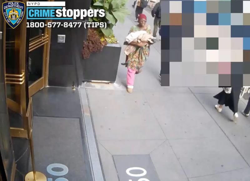The new images show a woman holding what appears to be a bundle of blankets in the area of Penn Station