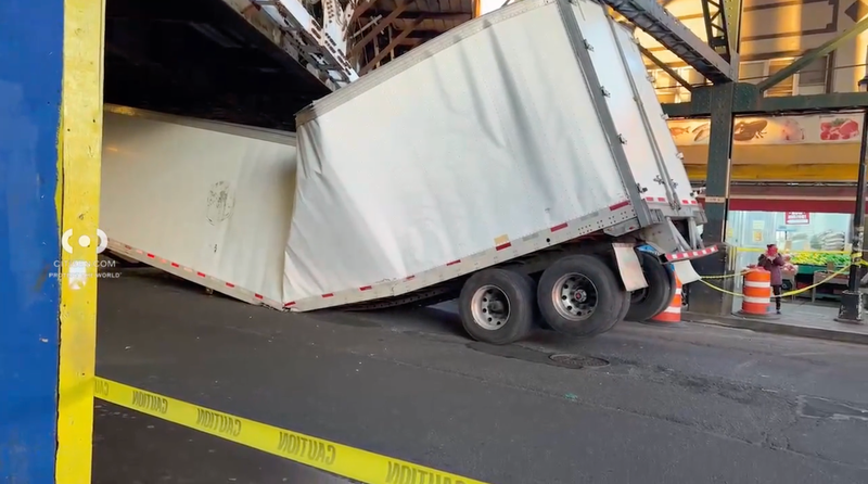 A tractor-trailer truck driver crashed into the elevated Woodside 7 train station on Thursday morning