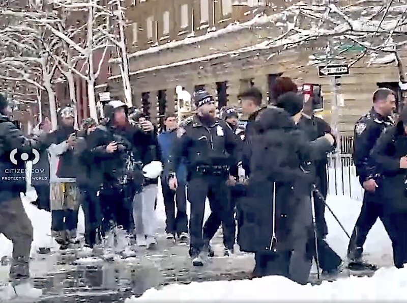 Videos show a large crowd throwing snowballs at multiple NYPD officers during the snowball fight at Washington Square Park