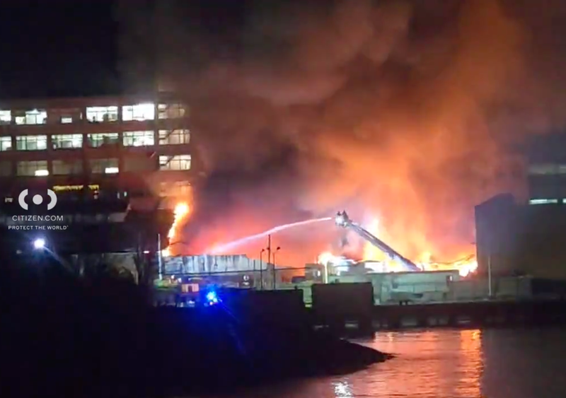 Two firefighters were injured early Wednesday as the FDNY battled a five-alarm fire at factory buildings on the Brooklyn waterfront