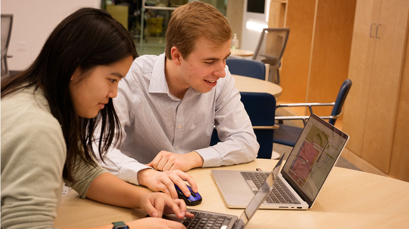 Sophia Liu and Griggs Fuller at work digitizing maps in the UChicago Library’s Center for Digital Scholarship.