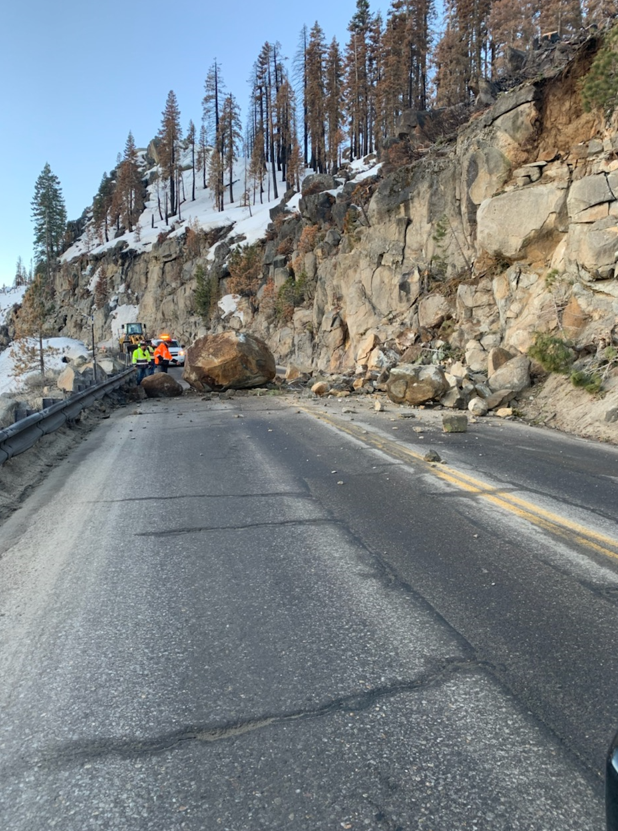 Crews works to clear a boulder on the roadway at Echo Summit.