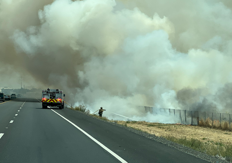 Firefighters battle a three-alarm grass fire at Highway 12 and Beck Avenue in Fairfield.