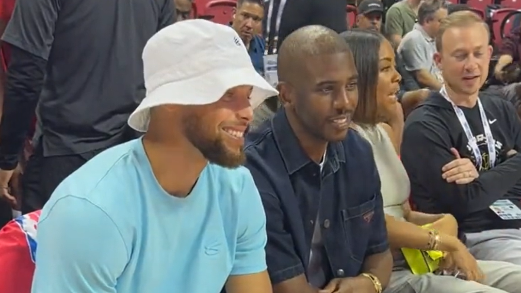 Chris Paul sits courtside with Steph Curry at Warriors summer league game