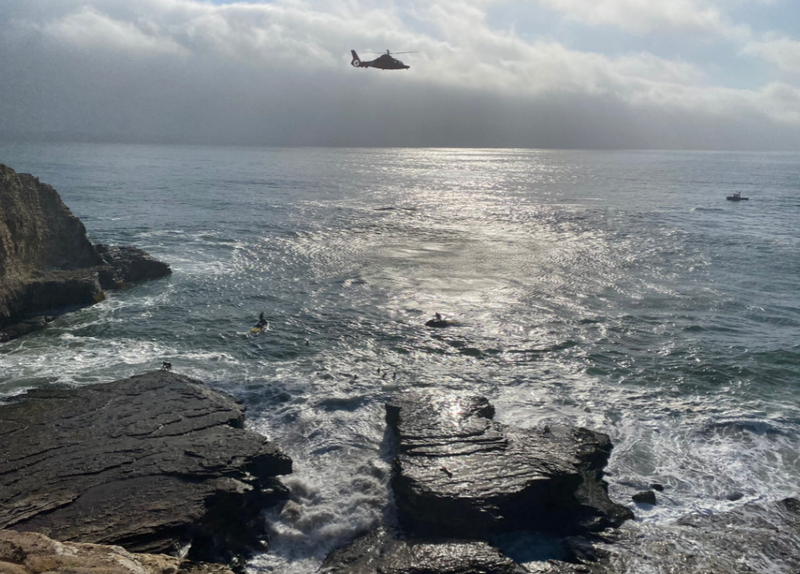 Searchers look for a swimmer at Panther State Beach on Tuesday afternoon.