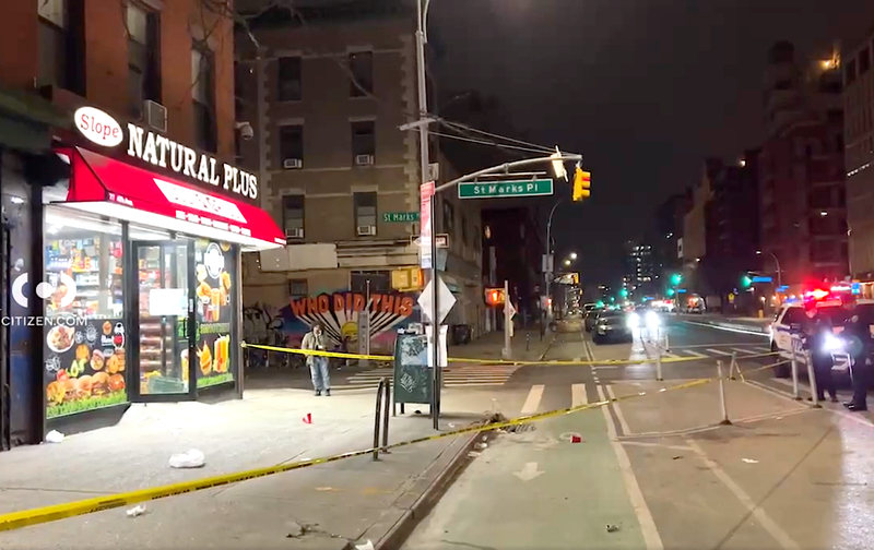 Police investigate at the scene of the stabbing on Sunday morning