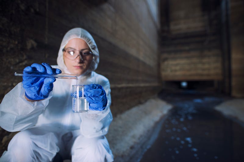 A female scientist test a sewer sample
