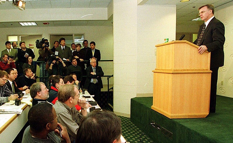 Cliff Christl (seated at the far end of the back row) listens as former Packers head coach Mike Sherman speaks at a news conference in 2000 at Lambeau Field. Christl was an award-winning sportswriter whose career spanned more than 35 years with the Milwaukee Journal Sentinel and the Green Bay Press-Gazette, primarily covering the Packers as a beat writer and columnist. Mike Sherman