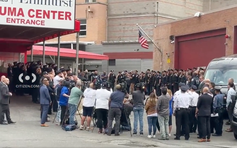 NYPD officers gather to support the two officers as they leave Elmhurst Hospital.