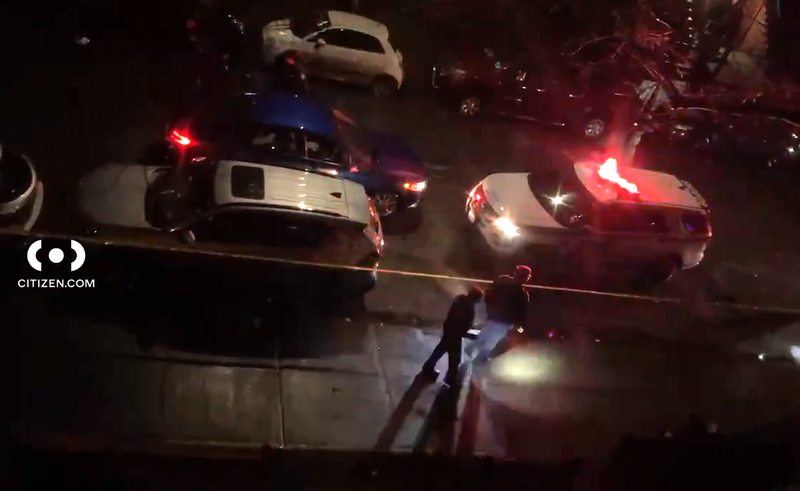 Police investigate at the scene where a 28-year-old man was shot and killed in Brownsville