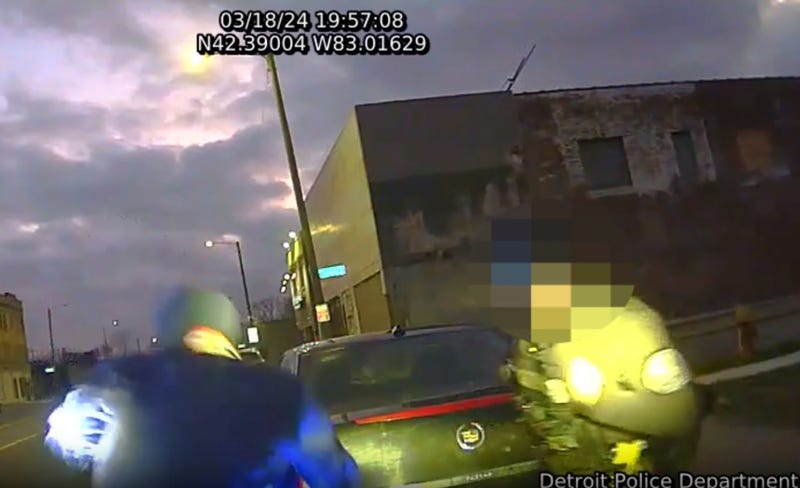 Driver and Detroit police officer duck as shots are fired during traffic stop