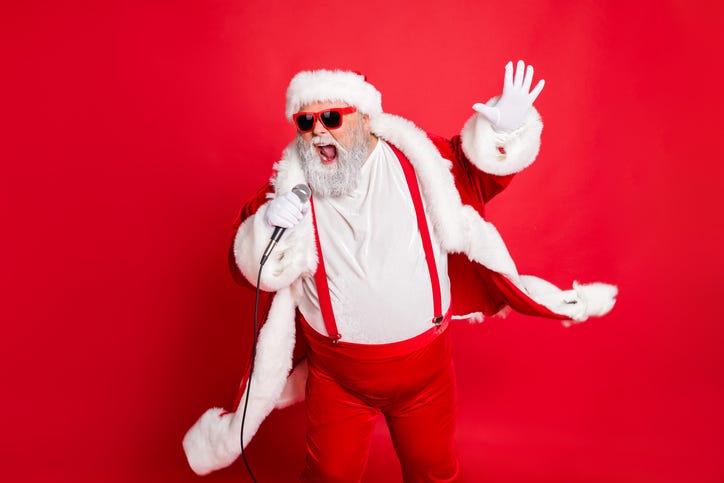 Singing Santa with microphone in front of red background