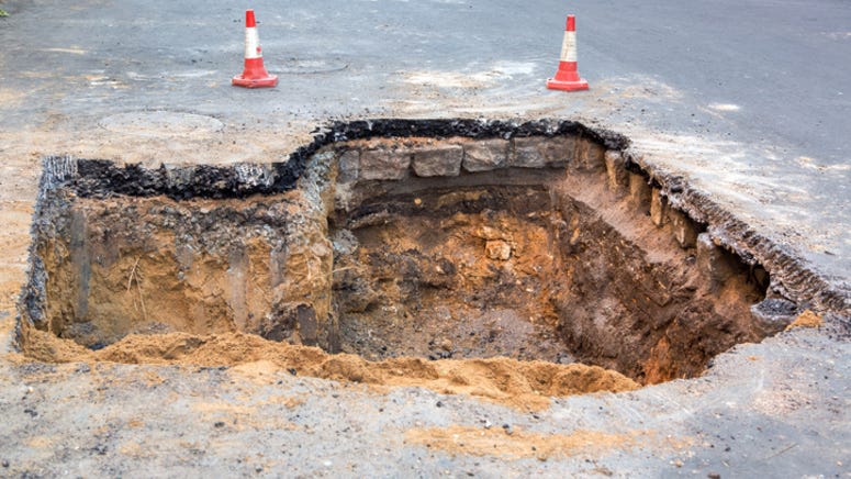 Texas woman saved from car seconds before it’s swallowed by flooded sinkhole