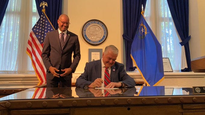 Nevada Governor Steve Sisolak signs police reform bills as Nevada Atty General Aaron Ford watches