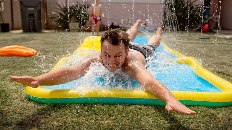 Dad saves daughter from Slip 'n Slide with impressive reflexes at the last second