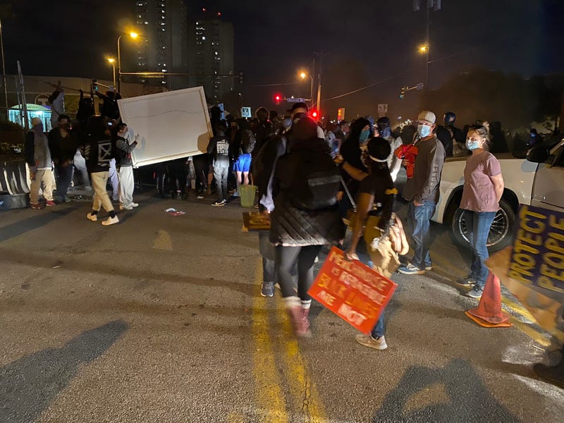 Protesters carrying large item