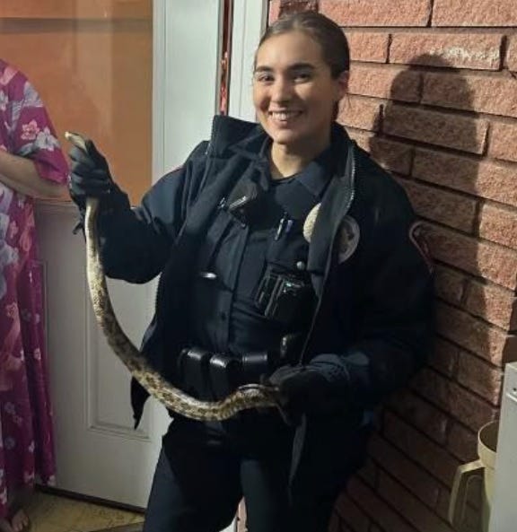Officer Lynch with a snake she removed from a Mansfield home.
