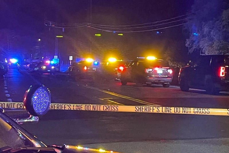 sheriff vehicles behind police tape