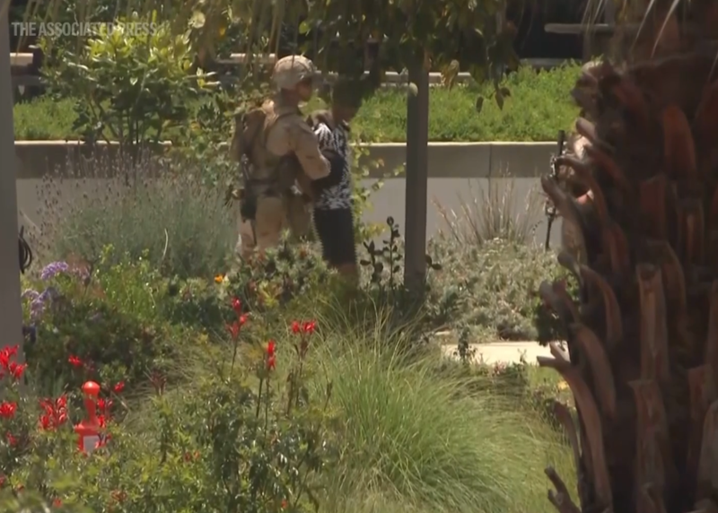 U.S. Marines deployed Friday to guard a federal building in Los Angeles appeared to detain and handcuff a young man outside.