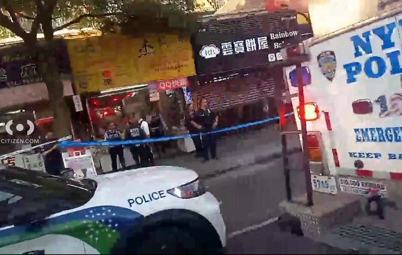 NYPD officers stand outside the spa after the stabbing around 5:40 p.m. Tuesday