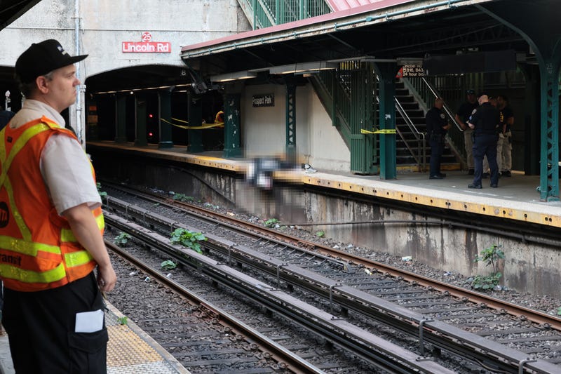 NYPD officers investigate the scene of a man hit by a train at the Prospect Park subway stop on July 30, 2025