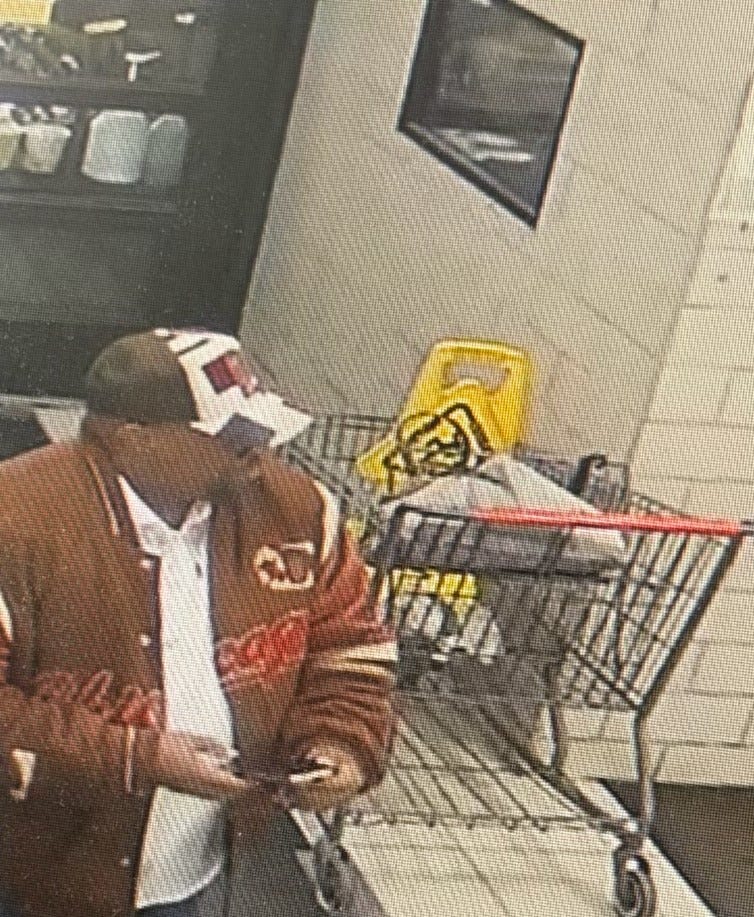 Man with shopping cart and phone