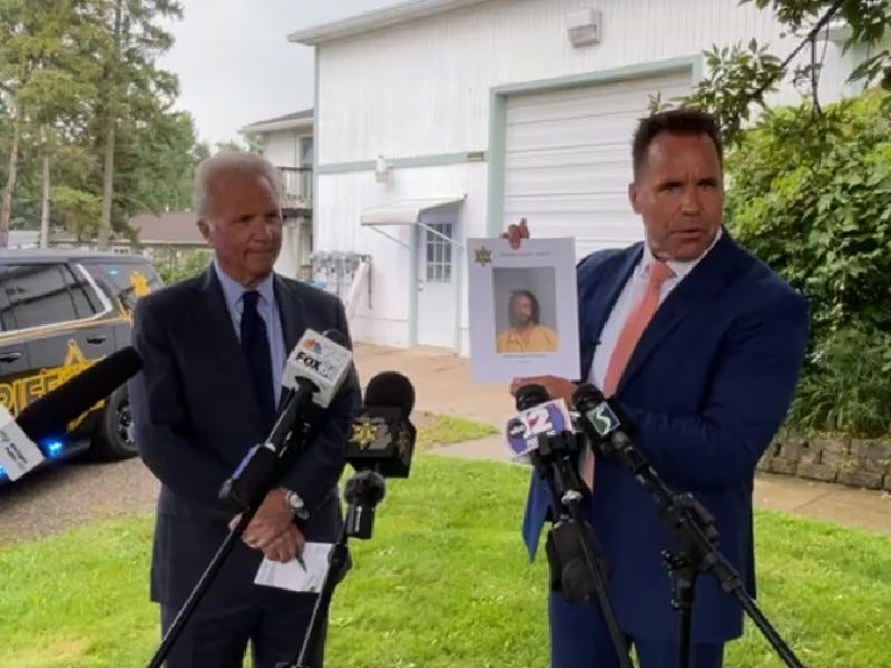 Sheriff Chris Swanson holds photo of suspect Omar Brogdon