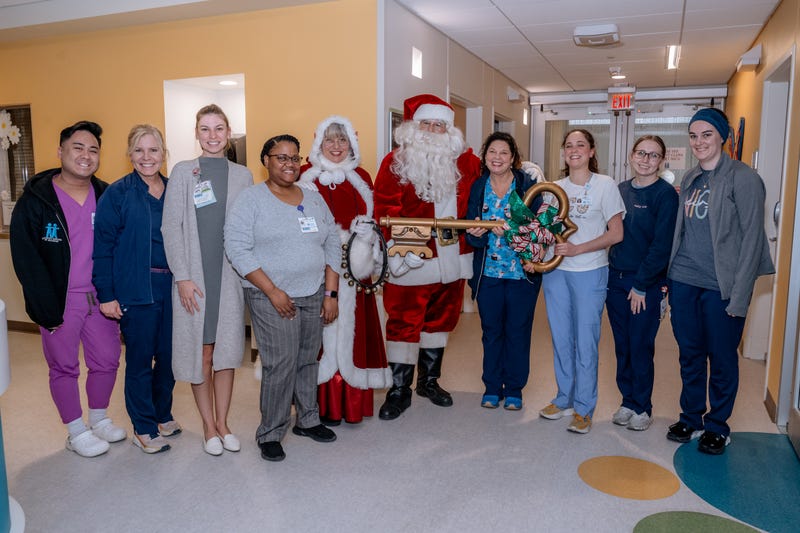 Santa, Mrs. Claus with nurses in scrubs