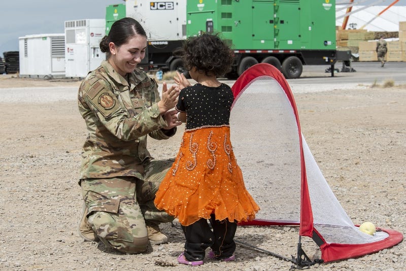 Airmen plays with Afghan girl