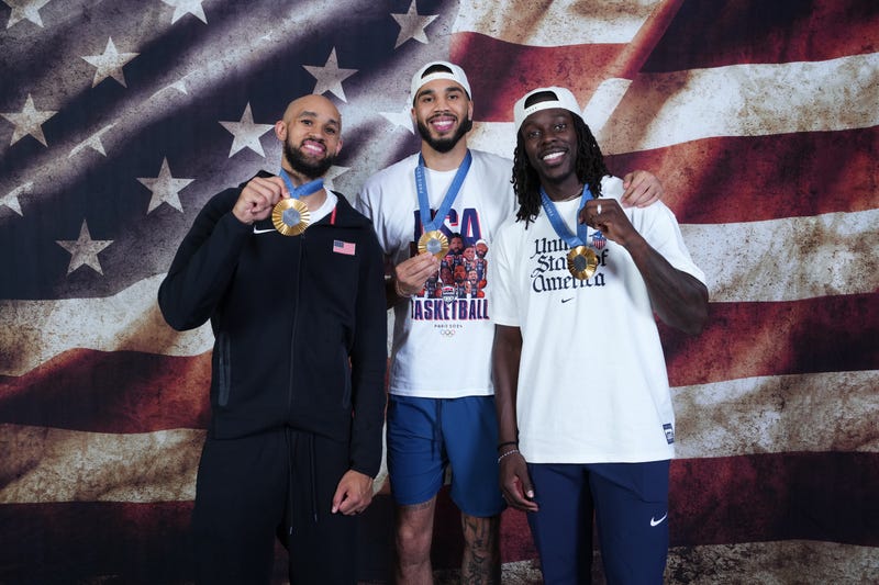 Jayston Tatum, Derrick White, and Jrue Holiday pose with their Olympic gold medals.