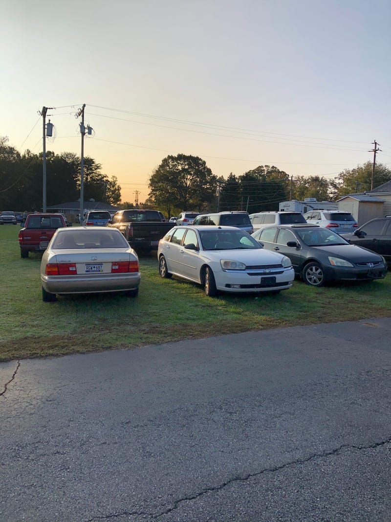 Voters park in the grass before voting at a Taylors precinct