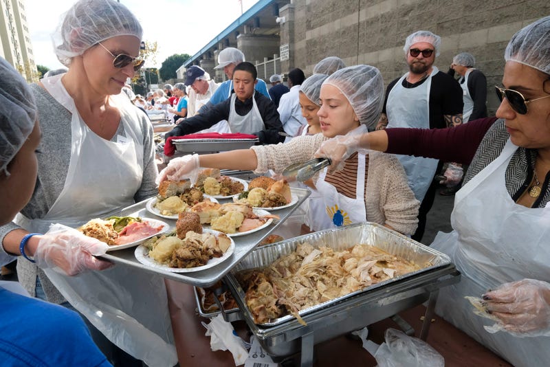 Servers dish out Thanksgiving foods for a charity meal in LA