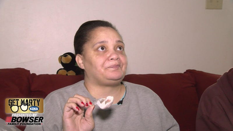 Tiffany France shows the prosthetic that replaced the roof of her mouth after surgery to remove her tumor.