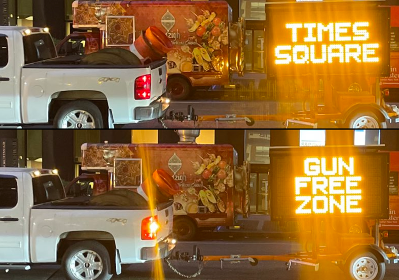 Signs flashing "TIMES SQUARE: GUN FREE ZONE" were being driven around Midtown Manhattan on Tuesday