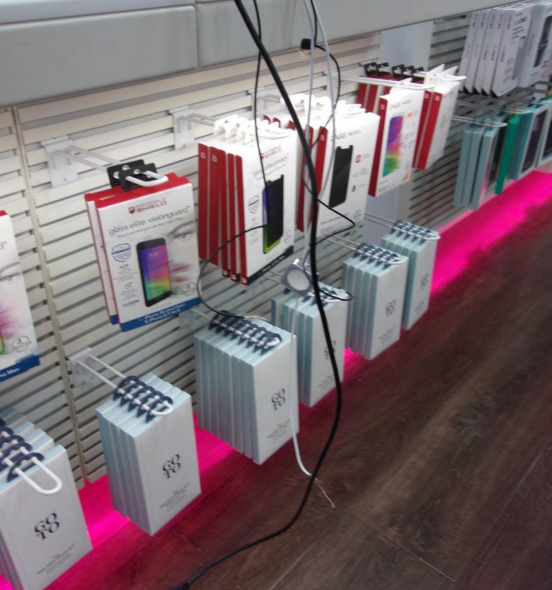 Scene from inside T-Mobile store after three men stole display items, including iPhones and Apple Watches.