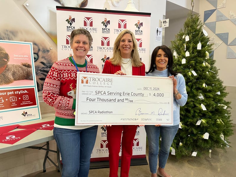 Robin Wolfgang of Trocaire College presenting a $4K check to the SPCA Serving Erie County