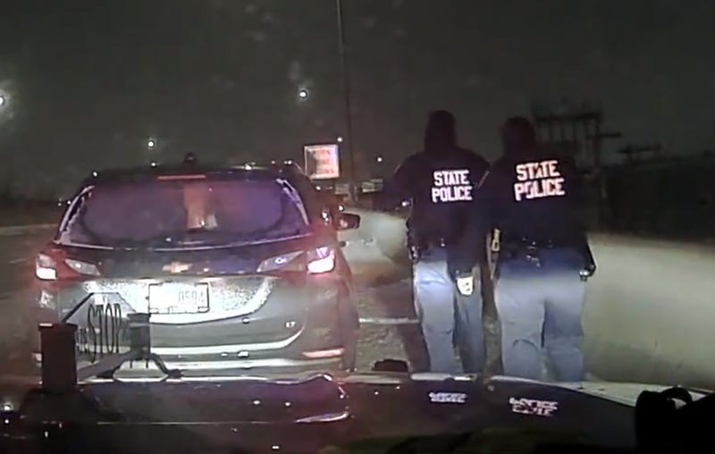 One state trooper is hospitalized Saturday morning after she was pinned between a vehicle and a concrete barrier while on the scene of a multi-vehicle crash in Detroit overnight, authorities said.