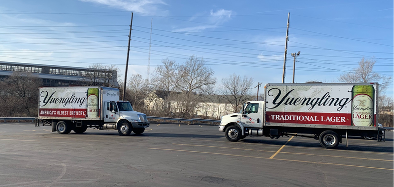 two yuengling trucks in a parking lot