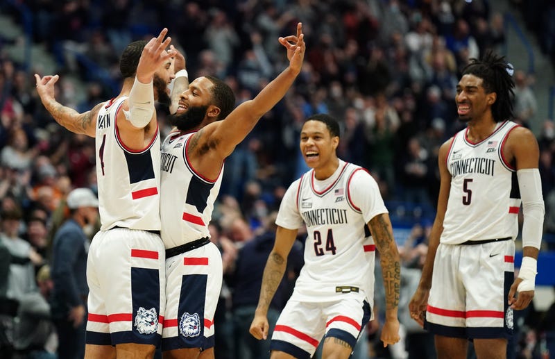Connecticut Huskies guard Tyrese Martin (4) reacts after his three point basket with guard R.J. Cole (2), guard Jordan Hawkins (24) and forward Isaiah Whaley (5) against the Marquette Golden Eagles in the second half at XL Center.