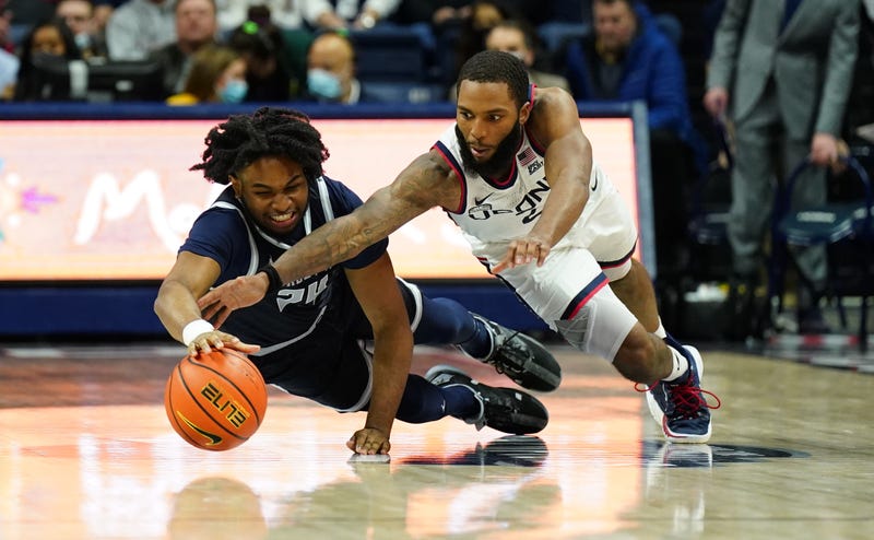 Connecticut Huskies guard R.J. Cole (2) and Georgetown Hoyas forward Kobe Clark (24) work for the ball in the second half at Harry A. Gampel Pavilion.