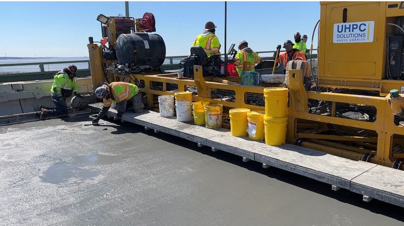 Road crews replace the deck on the older New Jersey-bound span of the Delaware Memorial Bridge.