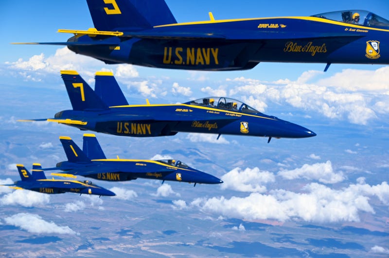The U.S. Navy Blue Angels, flying in a close formation.