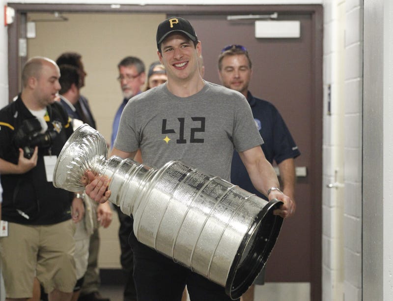 Pittsburgh, PA, USA; Pittsburgh Penguins center Sidney Crosby carries the Stanley Cup into PNC Park \