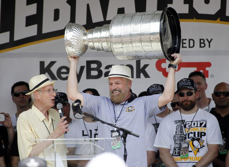  Pittsburgh Penguins broadcasters Mike Lange (left) and Phil Bourque (right) during the Stanley Cup championship parade 