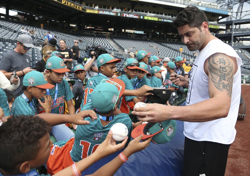  Pittsburgh Pirates catcher Francisco Cervelli (right) signs autographs for the team that represented Latin America in the Little League World Series