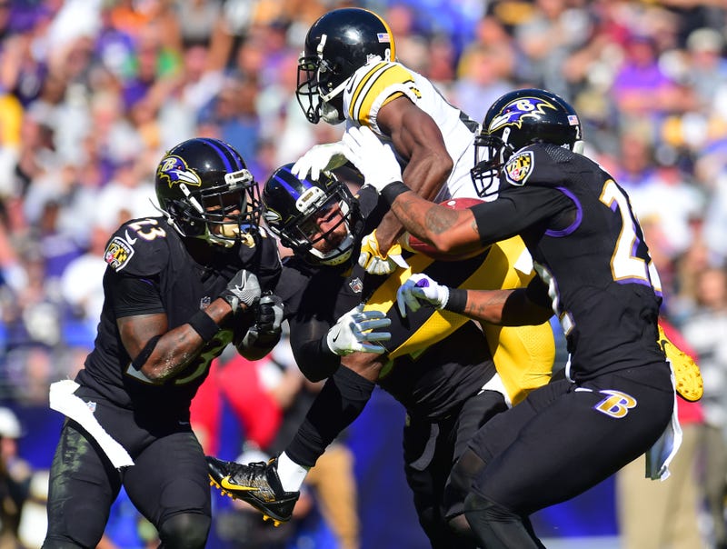Former Steelers WR Antonio Brown gets clobbered by a trio of Ravens defenders