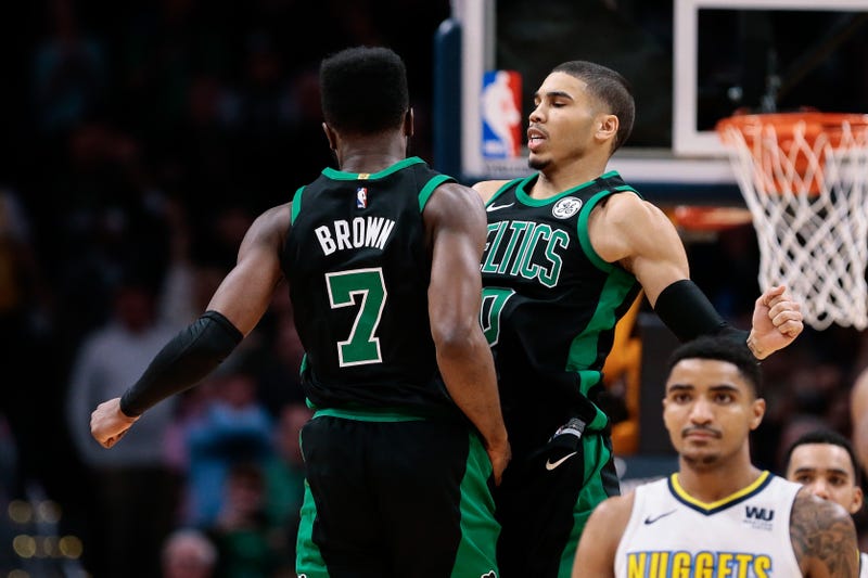 Jaylen Brown (7) celebrates with Jayson Tatum (0) after a play in the fourth quarter against the Denver Nuggets at the Pepsi Center in 2018.