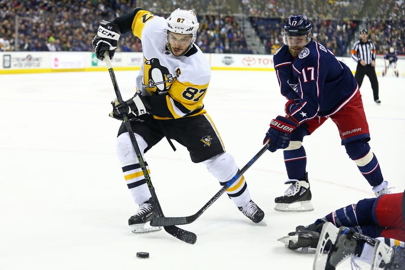 Sidney Crosby and Brandon Dubinsky battle over the puck