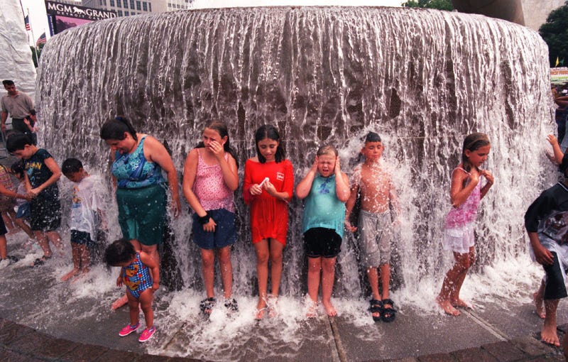 Kids play in the water fountain in Hart Plaza during the Detroit 300 celebration in July 2001