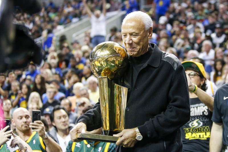 Oct 5, 2018; Seattle, WA, USA; Former Seattle Supersonics head coach Lenny Wilkens holds the 1979 championship trophy during a third quarter timeout of a game between the Sacramento Kings and Golden State Warriors at KeyArena.